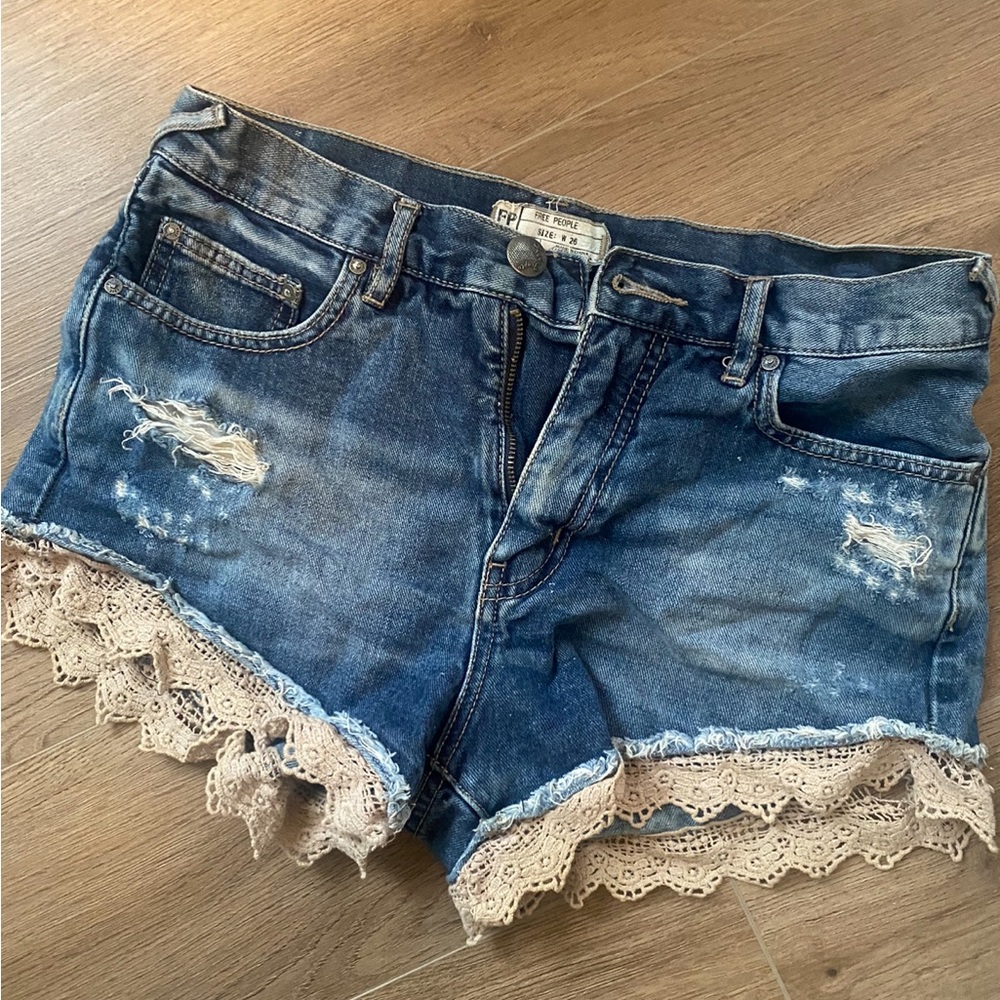 Free people distressed denim shorts with crochet detail
